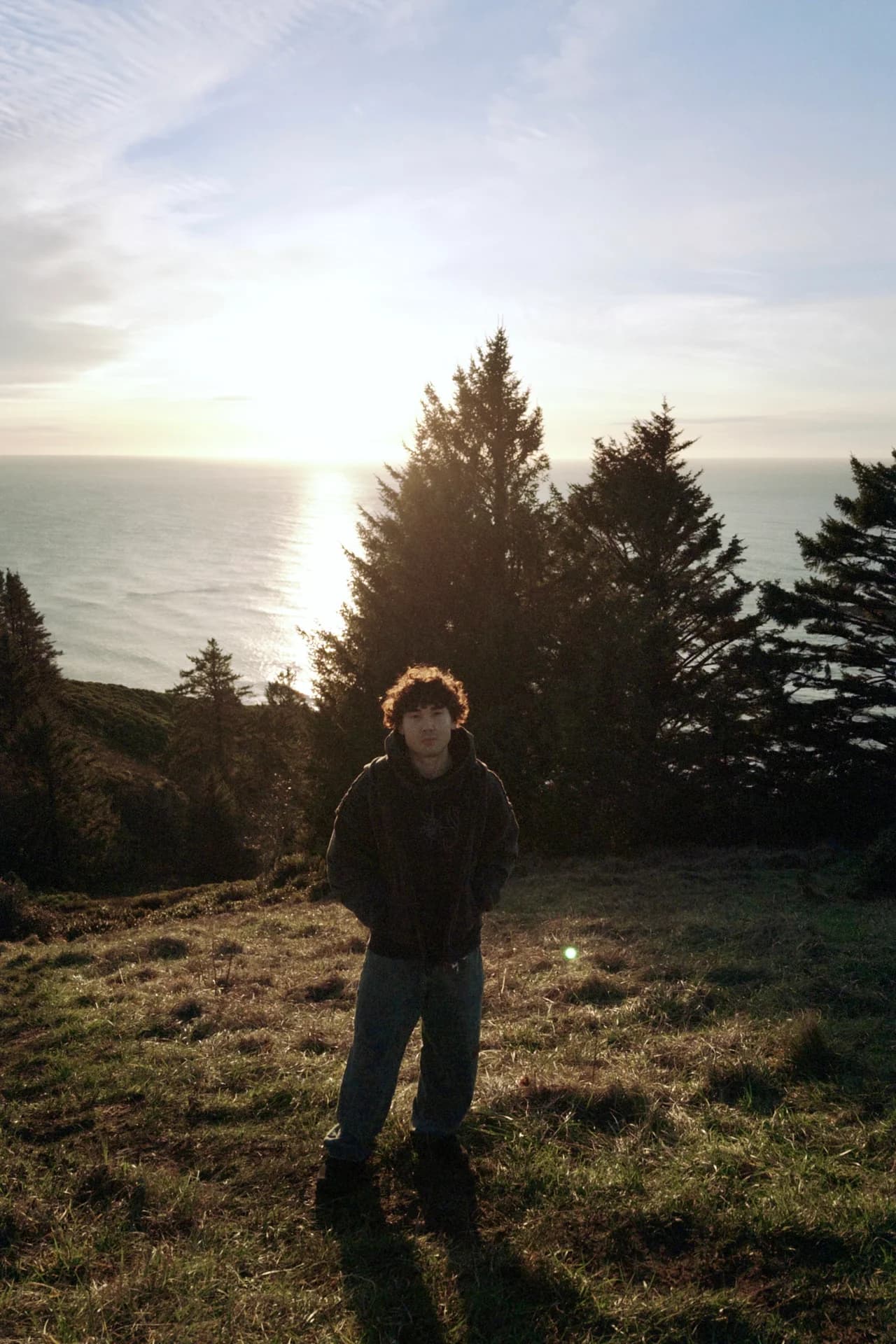 A portrait on a coastal trail at sunset