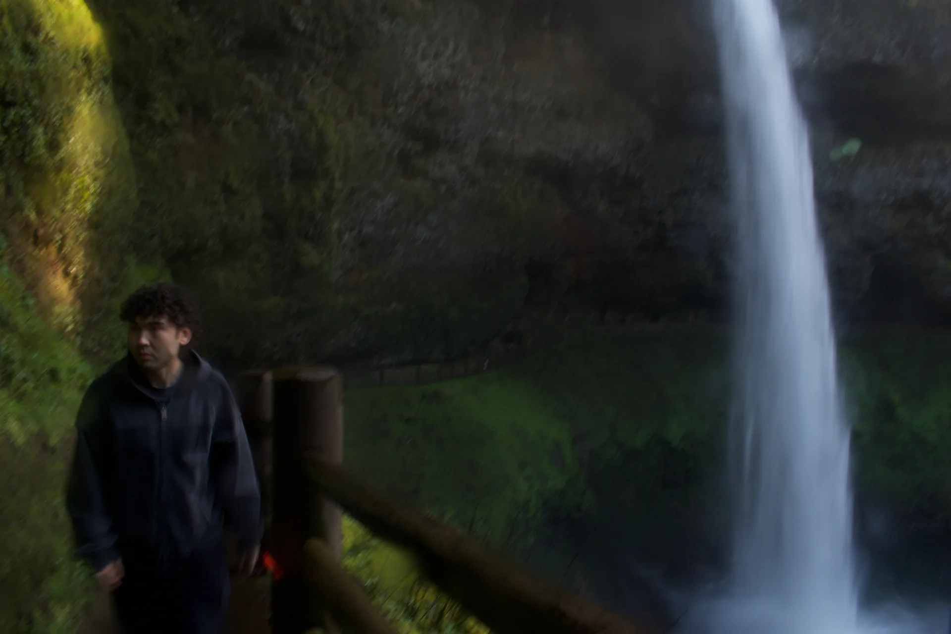 A portrait beside a waterfall
