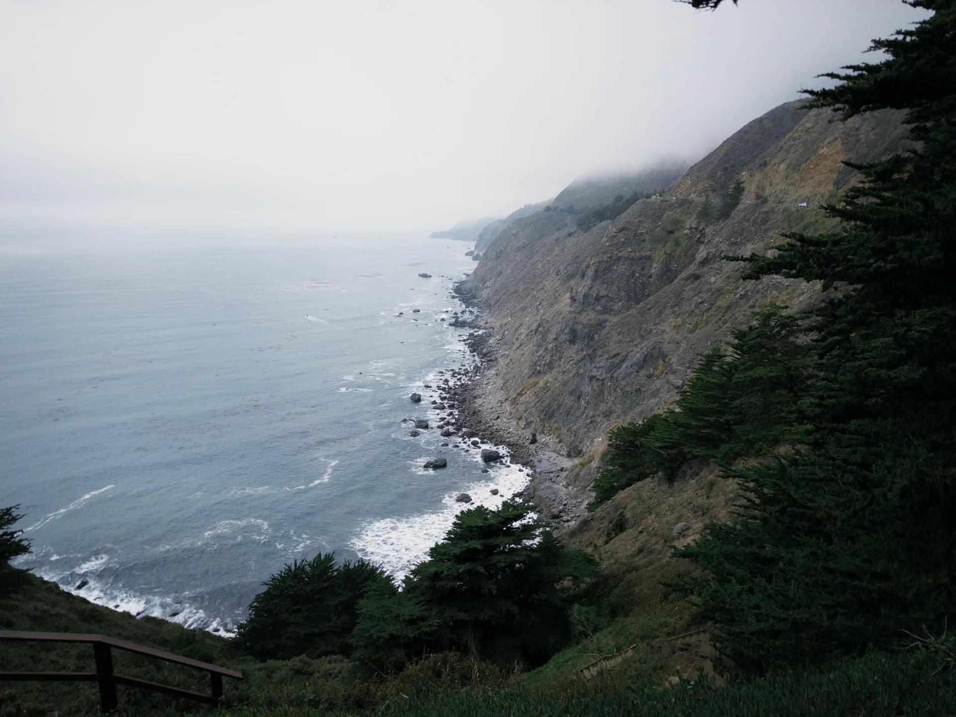 Coastal cliffs disappearing into the fog